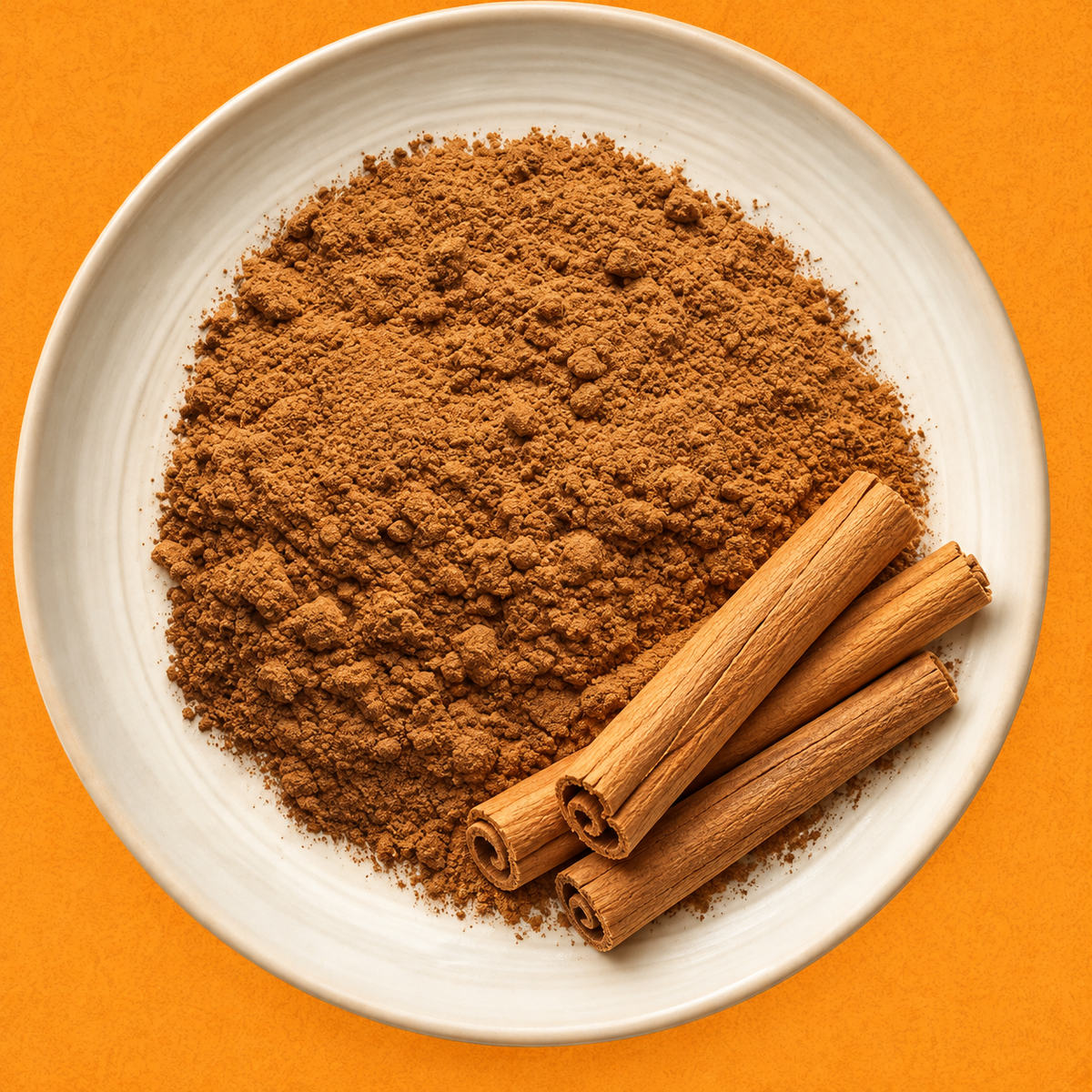 Organic ground Ceylon cinnamon in a small dish with cinnamon quills